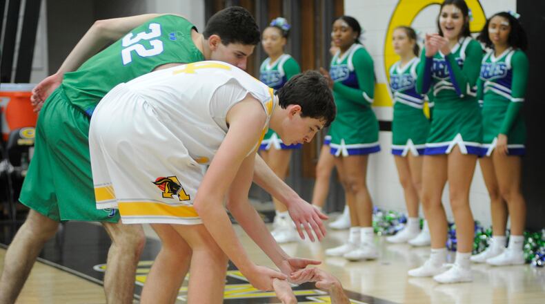 Dominic Ruffolo of Alter (right) gets a helping hand from teammate Conor Stolly and Daniel Nauseef of CJ. MARC PENDLETON / STAFF