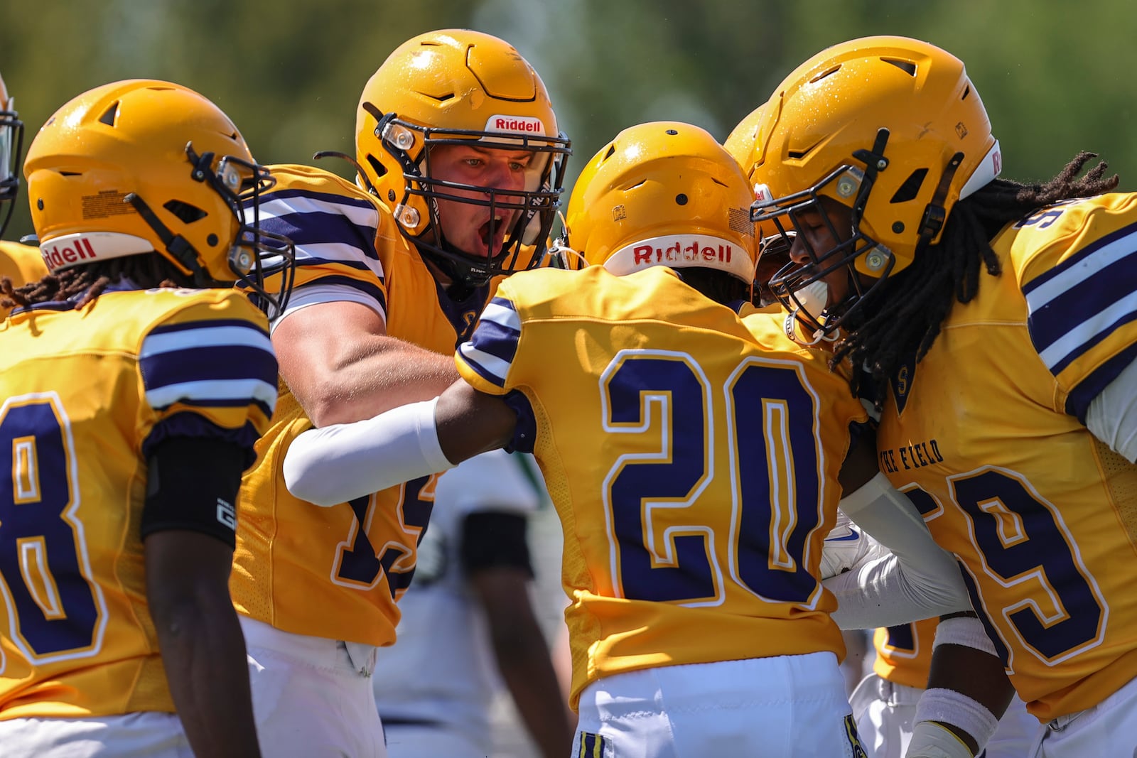 Springfield High School's Carter Bumgardner celebrates with teammates during their scrimmage game against Louisville Trinity earlier this month in Springfield. MICHAEL COOPER / STAFF