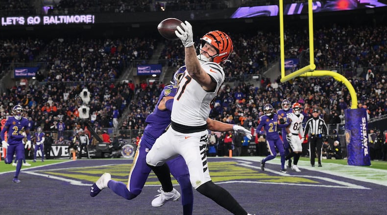 Cincinnati Bengals tight end Tanner Hudson (87) catches a touchdown pass against Baltimore Ravens safety Kyle Hamilton (14) during the second half of an NFL football game, Thursday, Nov. 27, 2025, in Baltimore. (AP Photo/Nick Wass)