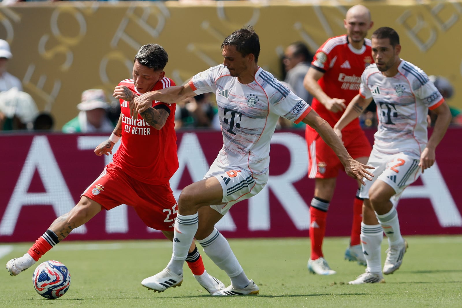 Benfica's Gianluca Prestianni, left, and Bayern Munich's Joao Palhinha fight for the ball during the Club World Cup Group C soccer match between Benfica and Bayern Munich in Charlotte, N.C., Tuesday, June 24, 2025. (AP Photo/Nell Redmond)