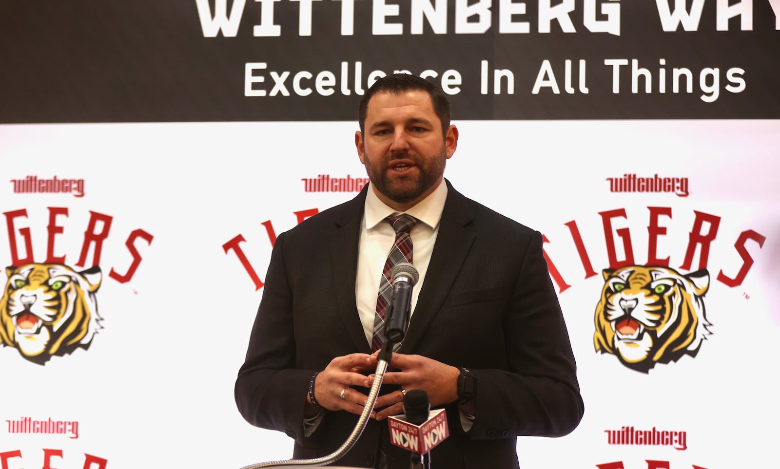BJ Coad, left, speaks at a press conference after being introduced as Wittenbergh's new head football coach on Monday, Dec. 1, 2025, at the The Health, Wellness & Athletics Complex in Springfield. David Jablonski/Staff