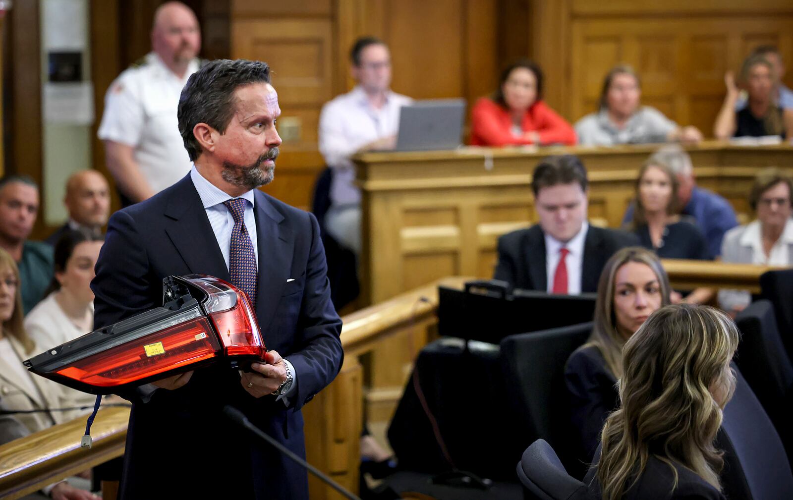 Defense attorney Alan Jackson questions accident reconstruction specialist Dr. Daniel Wolfe while holding a 2021 Lexus SUV taillight assembly during Karen Read's murder trial in Norfolk Superior Court in Dedham, Mass., Friday, June 6, 2025.(Mark Stockwell/The Sun Chronicle via AP, Pool)