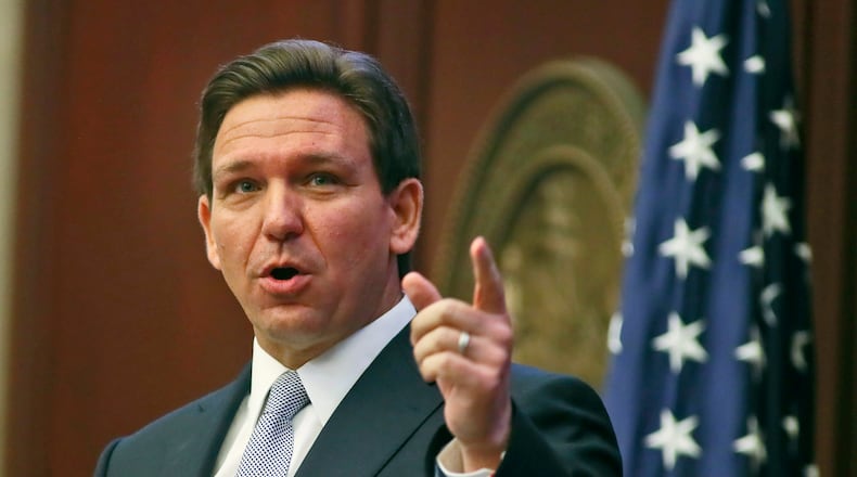 Florida Gov. Ron DeSantis gestures as he gives his State of the State address during a joint session of the Senate and House of Representatives Tuesday, March 7, 2023, at the Capitol in Tallahassee, Fla. (AP Photo/Phil Sears)
