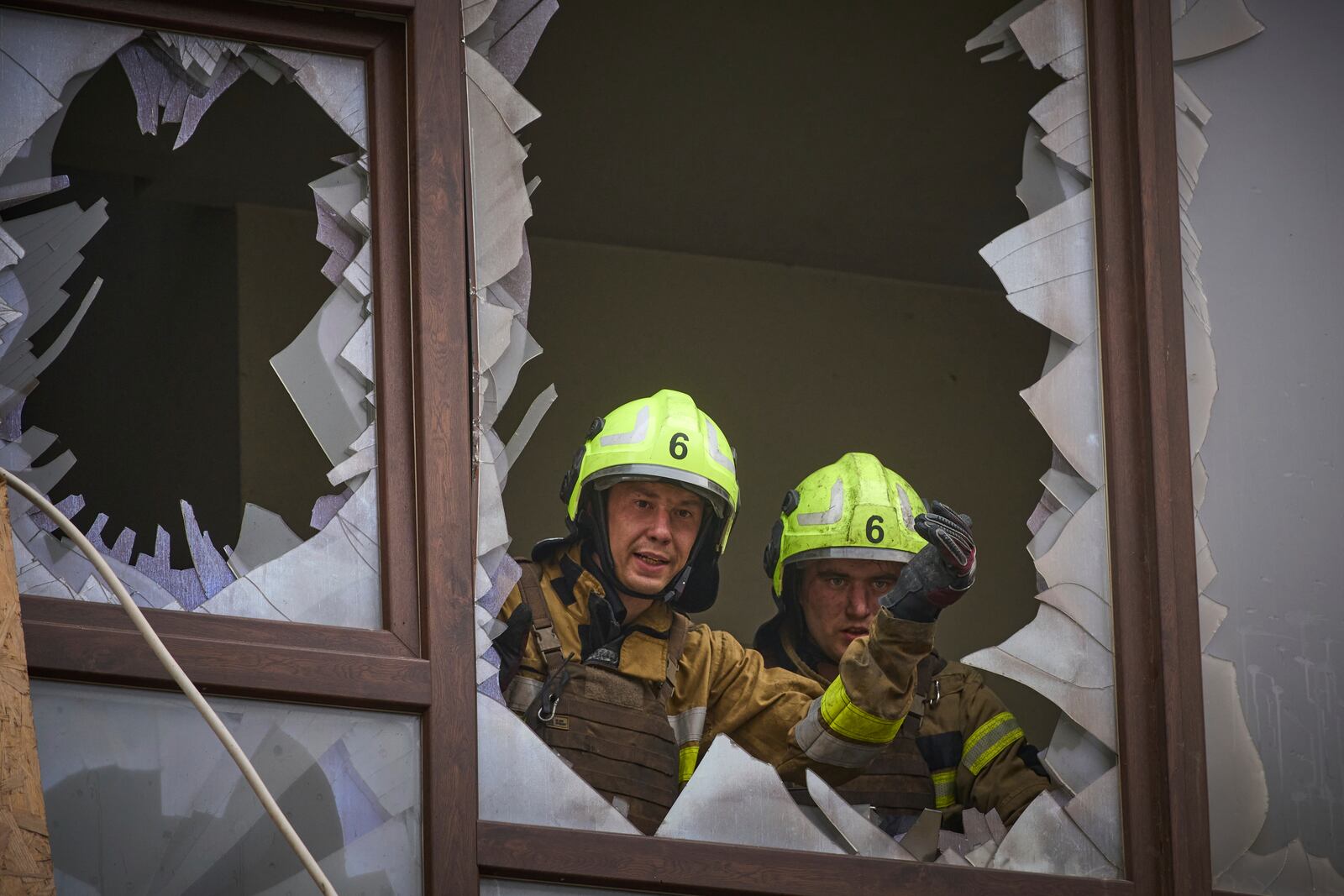 Firefighters work in a destroyed apartment building after a Russian attack in Kyiv, Ukraine, Monday, July 21, 2025. (AP Photo/Efrem Lukatsky)