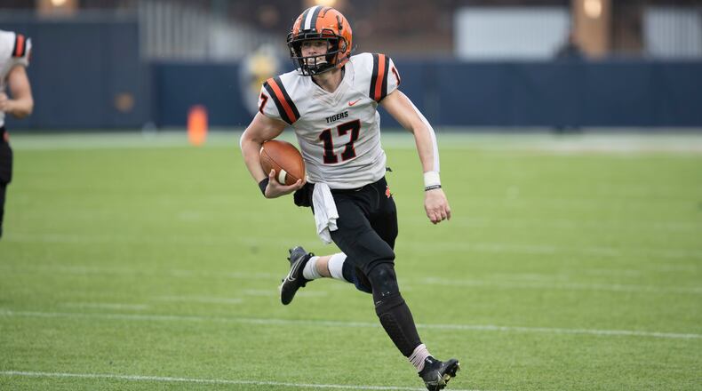 Versailles quarterback Michael Osborne looks for room to run vs. Kirtland in the Division VI state championship game at Tom Benson Hall of Fame Stadium in Canton on Dec. 1, 2023. Michael Cooper/CONTRIBUTED
