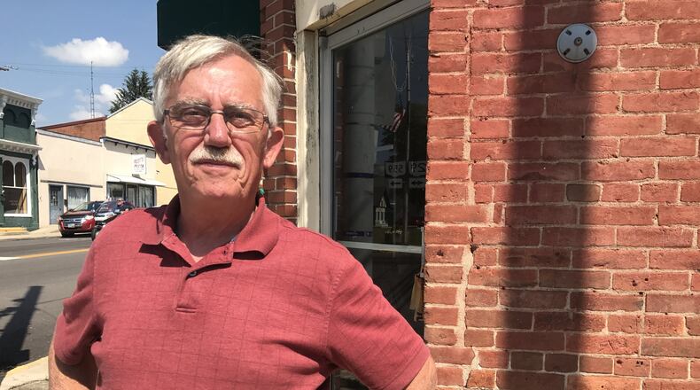 Mayor Greg Kimball stands in front of the vacant property the village plans to take ownership of soon. Katherine Collins/Staff
