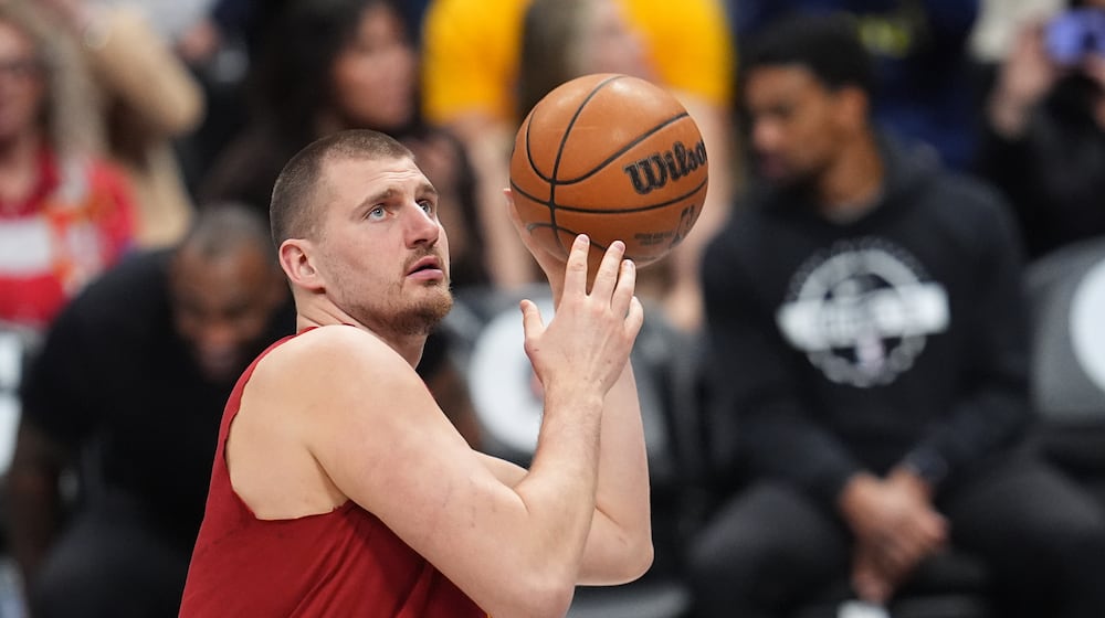 Denver Nuggets center Nikola Jokić warms up before an NBA basketball game against the Los Angeles Clippers, Friday, Jan. 30, 2026, in Denver. (AP Photo/David Zalubowski)