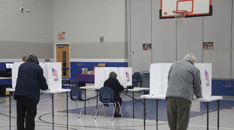 Voters fill out their ballots Tuesday. BILL LACKEY/STAFF