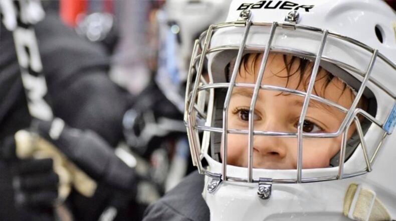 Cameron Bessery, a second grader at Snyder Park Elementary School with autism, has socially blossomed because of hockey and two high school students.