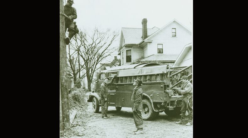 This photo from the mid-1950s shows Ohio Edison linemen working on a job in Springfield. In the 1940s and 1950s residential electrification was expanding greatly and there was improvement in safety standards and an increase in job opportunities to meet the demands. On the pole is Roger Burk Jr. and left to right is Bill Ringer, Foreman Keith Wheeler, and Tony Spencer. PHOTO COURTESY OF THE CLARK COUNTY HISTORICAL SOCIETY