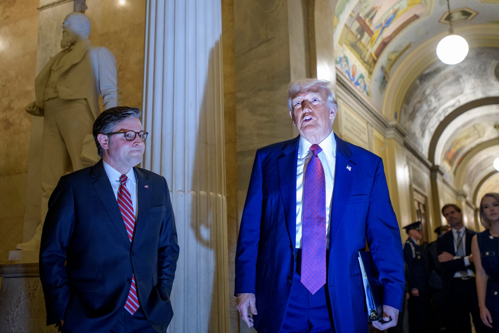 President Donald Trump, right, is joined by Speaker of the House Mike Johnson, R-La., as he arrives for a meeting with the House Republican Conference at the Capitol, Tuesday, May 20, 2025, in Washington. (AP Photo/Rod Lamkey, Jr.)