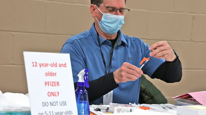 Doug Wyandt gets a COVID vaccine ready at the Clark County Combined Health District's vaccination center Thursday, Jan. 6, 2022. BILL LACKEY/STAFF