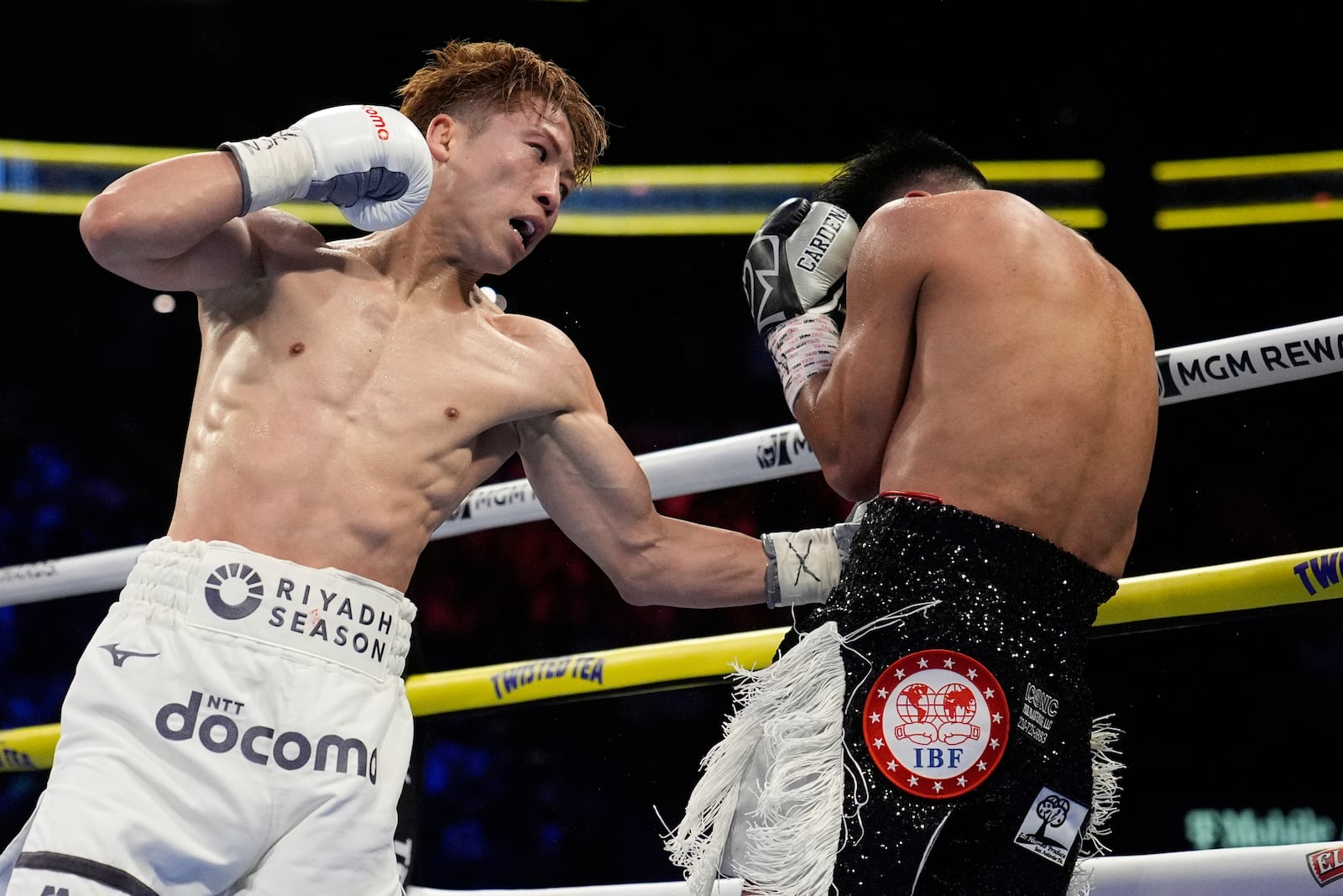 Naoya Inoue hits Ramon Cardenas in a junior featherweight title boxing match Sunday, May 4, 2025, in Las Vegas. (AP Photo/John Locher)