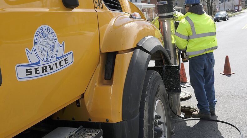 Springfield service workers clean out a sewer line Thursday. The city of Springfield is hosting financial forums ahead of its income tax issue on May 2. Bill Lackey/Staff