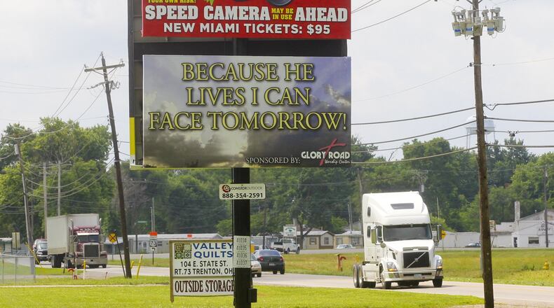 A new billboard warns motorist of the speed cameras set up in New Miami, Thursday, June 27, 2013. GREG LYNCH / STAFF