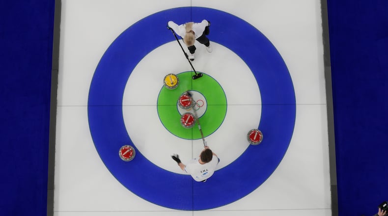 Estonia's Marie Kaldvee and Harri Lill compete during a curling mixed doubles round robin session against Italy at the 2026 Winter Olympics, in Cortina d'Ampezzo, Italy, Friday, Feb. 6, 2026. (AP Photo/David J. Phillip)