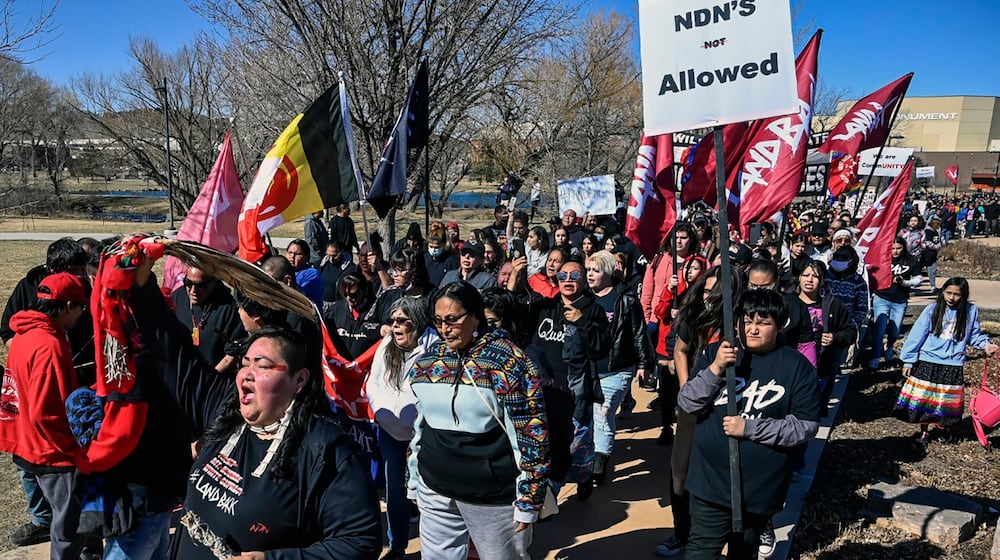 FILE - Demonstrators march from Memorial Park to the Andrew W. Bogue Federal building on Wednesday, March 23, 2022, in Rapid City, S.D., where it was announced that a federal civil rights lawsuit was filed against the Grand Gateway Hotel for denying services to Native Americans. (Matt Gade/Rapid City Journal via AP, File)