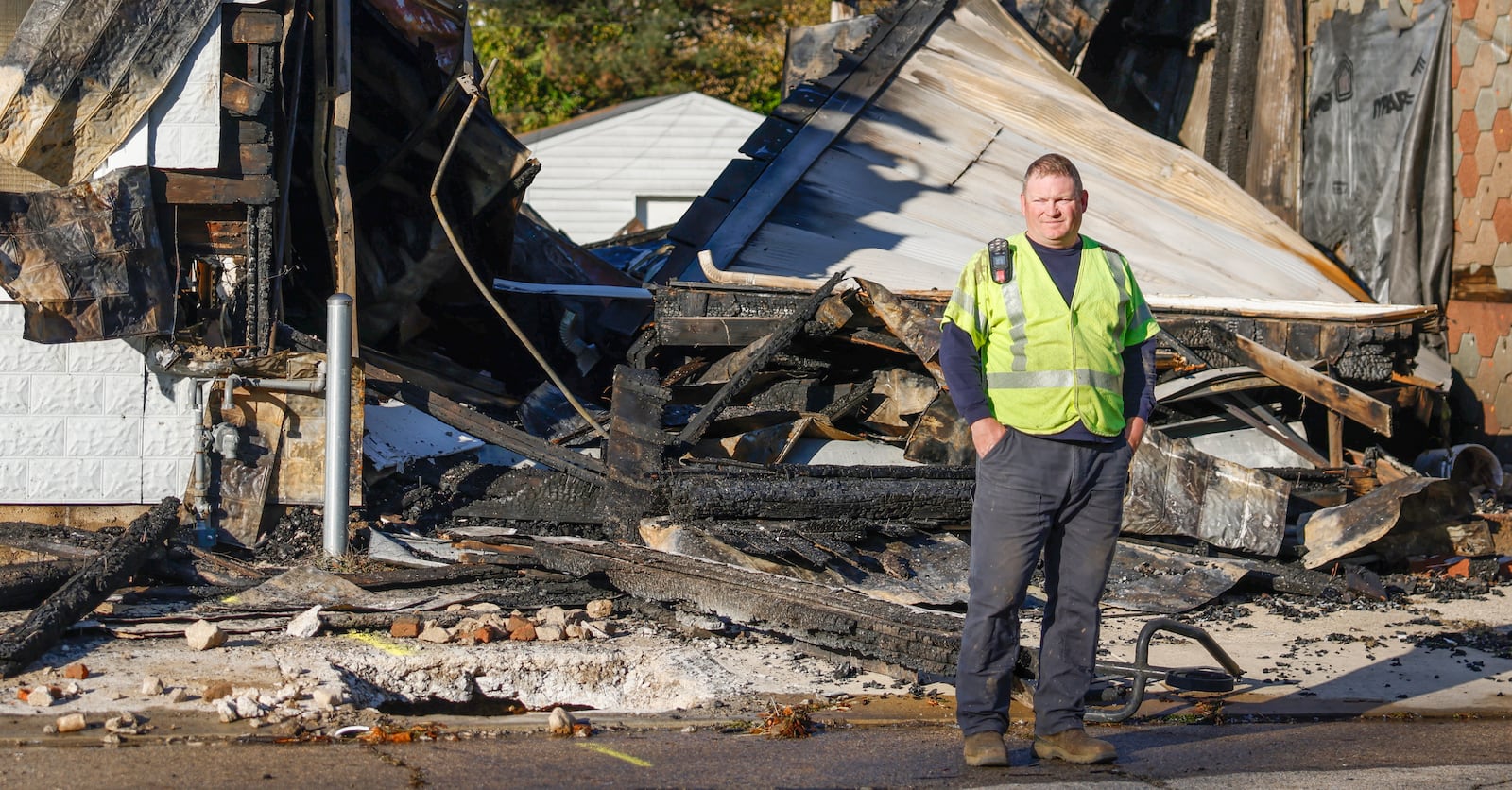 A worker inspects buildings on Monday, November 4, 2025, that are severely damaged after a fire on the 300 block of West Court Street in Urbana. JOSEPH COOKE/STAFF