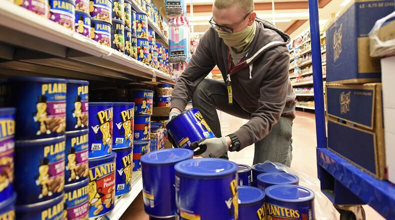 U.S. Air Force Airman Kevin Reed, 88th Air Base Wing Communications Squadron, stocks shelves as a volunteer at the Wright-Patterson Air Force Base commissary on April 9, 2020. (U.S. Air Force photo/Ty Greenlees)