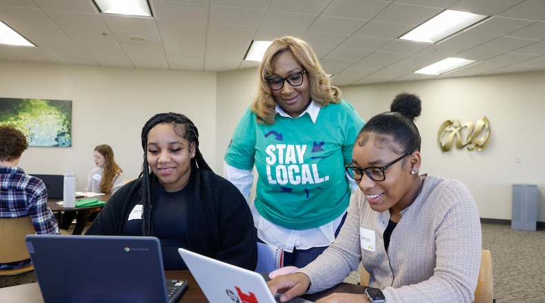 Jasmeir Johnson, left, a junior at Cliff Park High School, and Samiya Hammond, a freshman at Clark State College, show Lisa Cole, HR Manager at DOLE Fresh Vegetables, their resumes during a critique session at Magnify Internship Training Day through the Greater Springfield Partnership. JOSEPH COOKE / STAFF