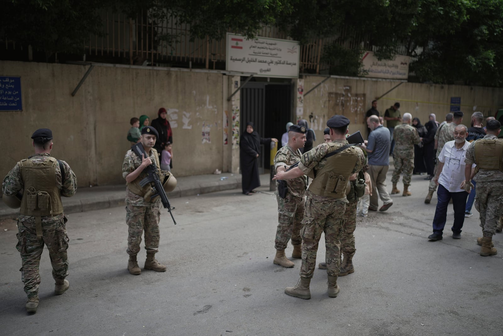 Lebanese army soldiers secure the area as voters arrive at a polling station during municipal elections in the southern suburbs of Beirut, Lebanon, Sunday, May 4, 2025. (AP Photo/Hassan Ammar)