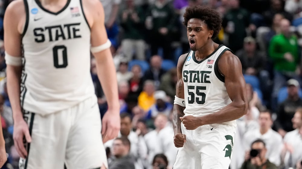 Michigan State forward Coen Carr (55) reacts after dunking against Louisville during the second half in the second round of the NCAA college basketball tournament, Saturday, March 21, 2026, in Buffalo, N.Y. (AP Photo/Yuki Iwamura)