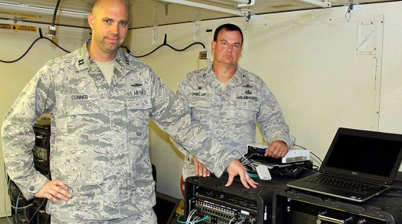 Col. Norman Poklar, of the Ohio Air National Guards 251st Cyber Engineering Installation Group and Capt. Craig Conner, of the 269th Combat Communications Squadron, point toward Joint Incident Site Communication Capability equipment that would be used in case of a natural disaster like Hurricane Katrina. Jeff Guerini/Staff