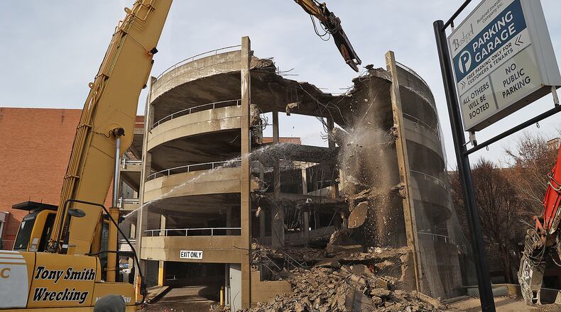A wrecking crew from Tony Smith Wrecking started demolishing the Bushnell Parking Garage Tuesday morning. BILL LACKEY/STAFF