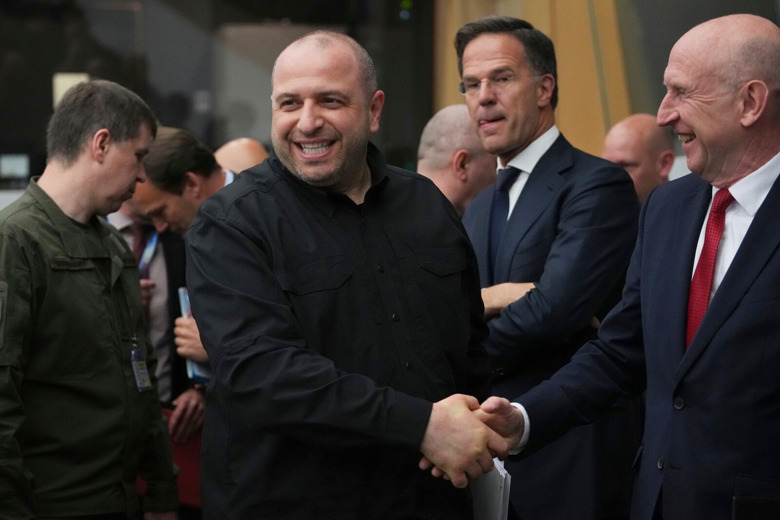 NATO Secretary General Mark Rutte, center, looks on as Ukraine's Defense Minister Rustem Umerov, center left, greets Britain's Defense Secretary John Healey during a meeting of the Ukraine Defense Contact Group at the NATO headquarters in Brussels, Wednesday, June 4, 2025. (AP Photo/Virginia Mayo)