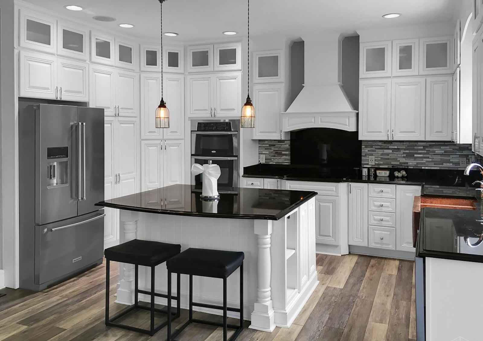 The fully updated kitchen has white cabinets, granite countertops, tile backsplash and stainless appliances as well as LVT flooring. CONTRIBUTED