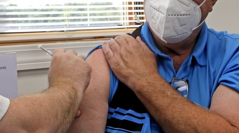 Basil Fett gets his COVID-19 booster shot at the Clark County Combined Health District Thursday, Sept. 8, 2022. BILL LACKEY/STAFF