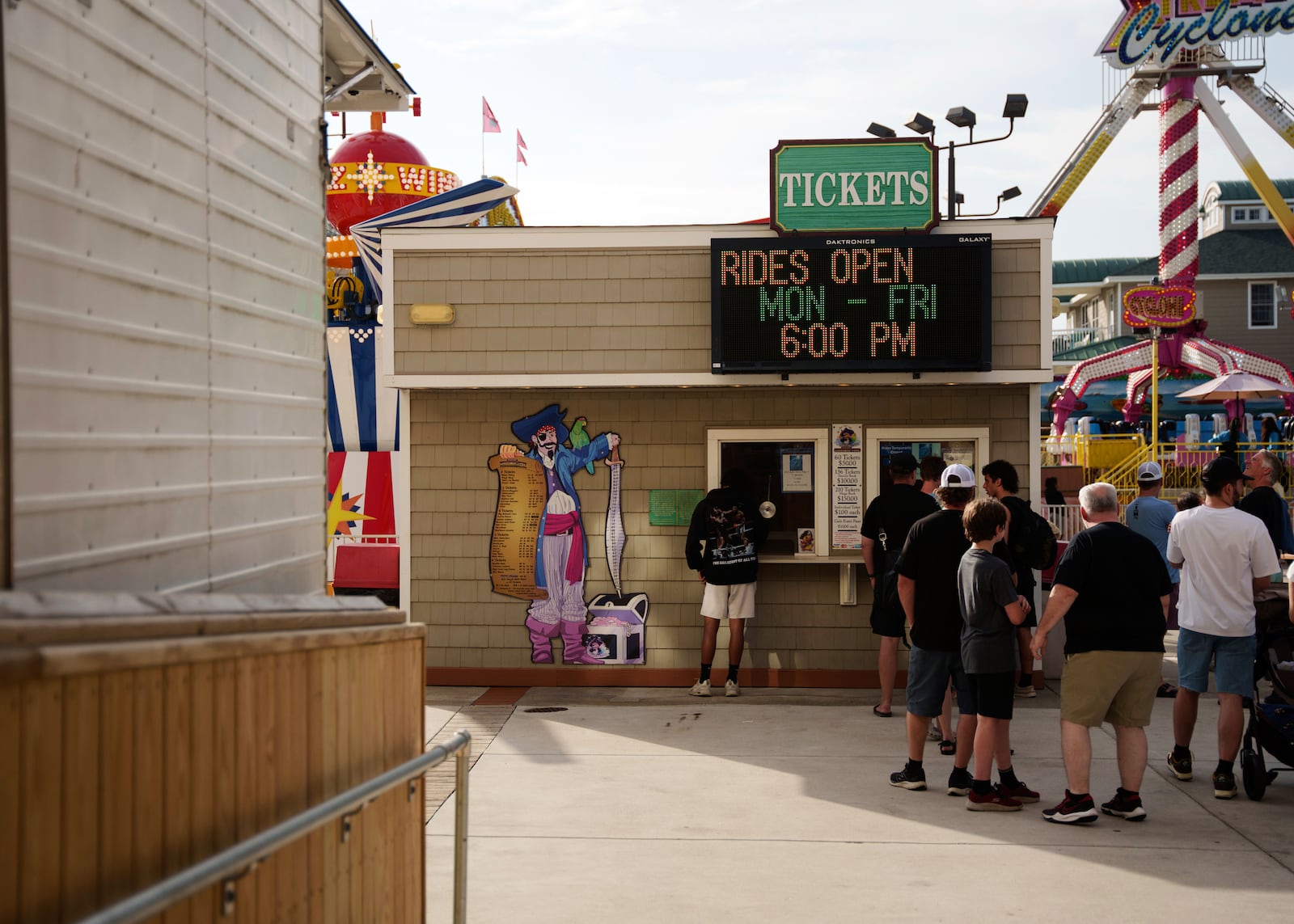 People line up for tickets at Playland's Castaway Cove amusement park, in Ocean City, N.J, on Friday, June 6, 2025. (AP Photo/Mingson Lau)