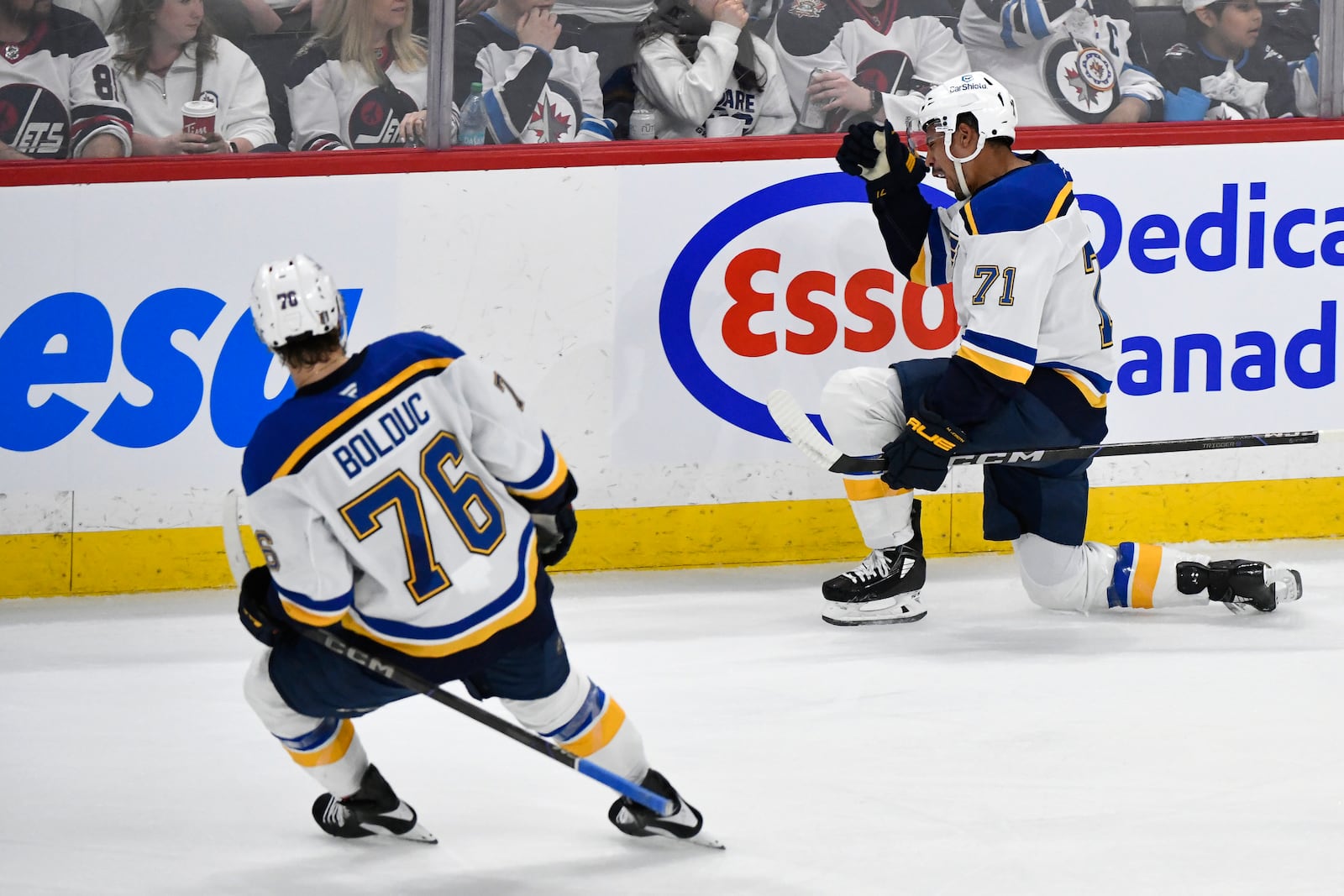 St. Louis Blues' Mathieu Joseph (71) celebrates after his goal against the Winnipeg Jets with Zack Bolduc (76) during the first period of Game 7 in an NHL hockey first-round playoff series in Winnipeg, Manitoba, Sunday, May 4, 2025. (Fred Greenslade/The Canadian Press via AP)