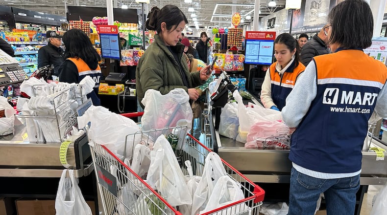 A shopper checks out at a cash register in a grocery store in Schaumburg, Ill., Monday, Feb. 9, 2026. (AP Photo/Nam Y. Huh)