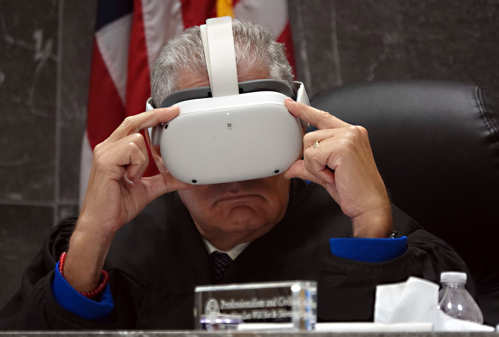 Judge Andrew Siegel watches a virtual reality presentation Thursday, Dec. 17, 2024, at the Broward County Courthouse in Fort Lauderdale during a hearing on the admissibility of a virtual reality depiction in a stand-your-ground case. Miguel Rodriguez Albisu, 59, owner of a wedding venue in Southwest Ranches, is accused of pulling a gun on wedding guests who did not clear out after he said they were supposed to have left. (Joe Cavaretta/South Florida Sun-Sentinel via AP)