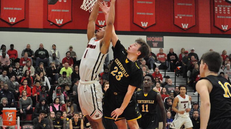 Wayne’s Deshon Parker (left) and Centerville’s Ryan Marchal battle for a rebound during the Warriors 52-49 win at home Feb. 16, 2018. NICK DUDUKOVICH / CONTRIBUTED