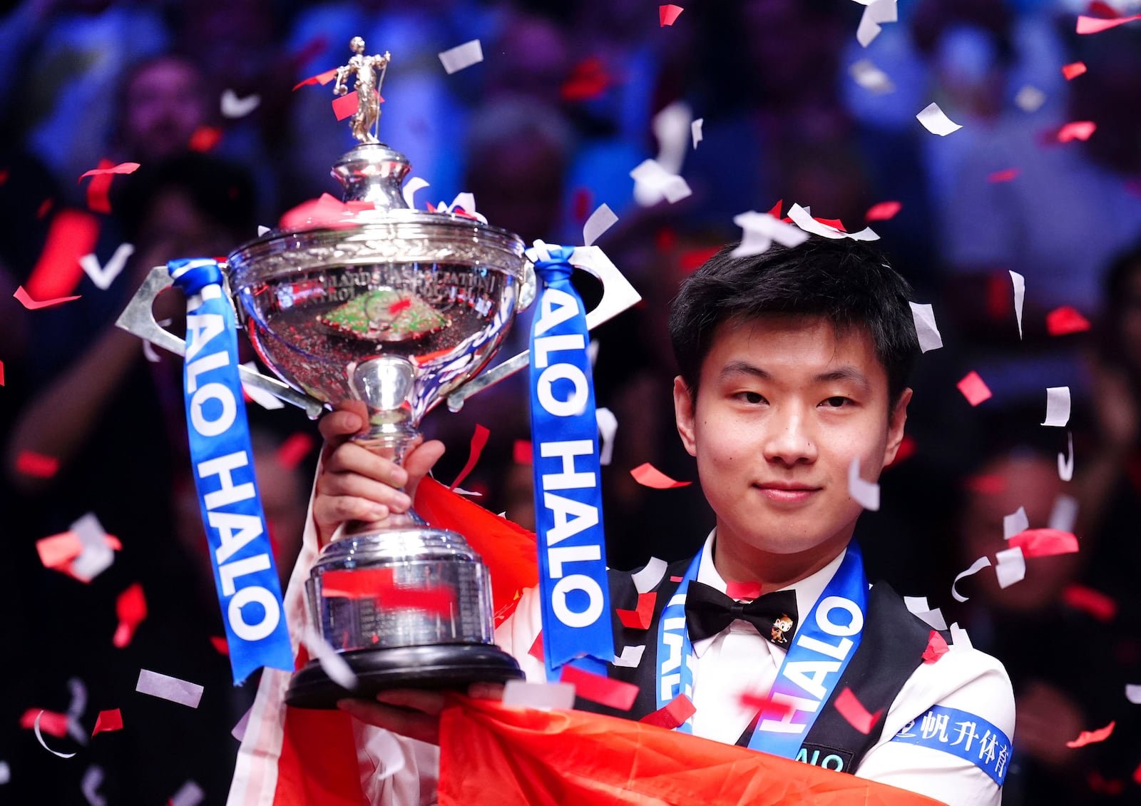 China's Zhao Xintong celebrates victory in the final match against Wales' Mark Williams following day seventeen of the World Snooker Championship at the Crucible Theatre, Sheffield, England, Monday, May 5, 2025. (Mike Egerton/PA via AP)
