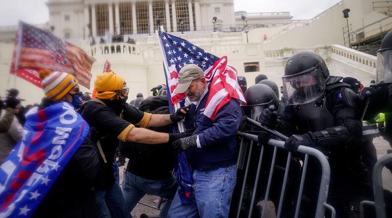 FILE - Rioters try to break through a police barrier at the Capitol on Jan. 6, 2021, in Washington. (AP Photo/John Minchillo, File)
