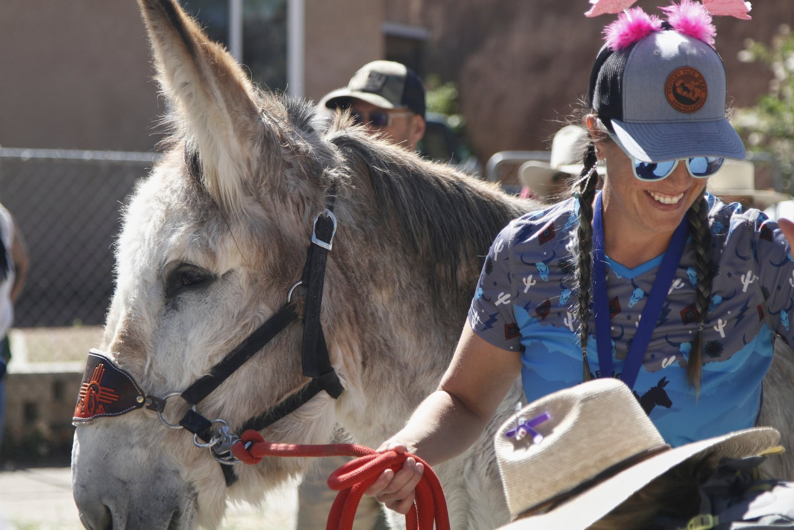 Pack burros and their human companions race through the streets of a former mining town and across backcountry desert trails in Cerrillos, N.M., on Saturday, May 3, 2025. (AP Photo/Morgan Lee)