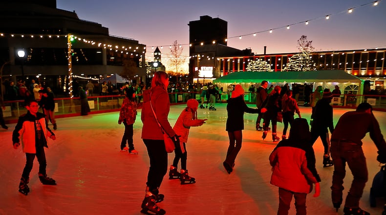 The Holiday in the City festivities got started Friday evening, Nov. 25, 2022 with the arrival of Santa, who lit the Holiday Tree from a Springfield Fire Division aerial truck. The outdoor ice skating rink was officially opened and holiday characters were woundering the downtown area. The Grand Illumination kicked off a month of activities planned for downtown Springfield. BILL LACKEY/STAFF
