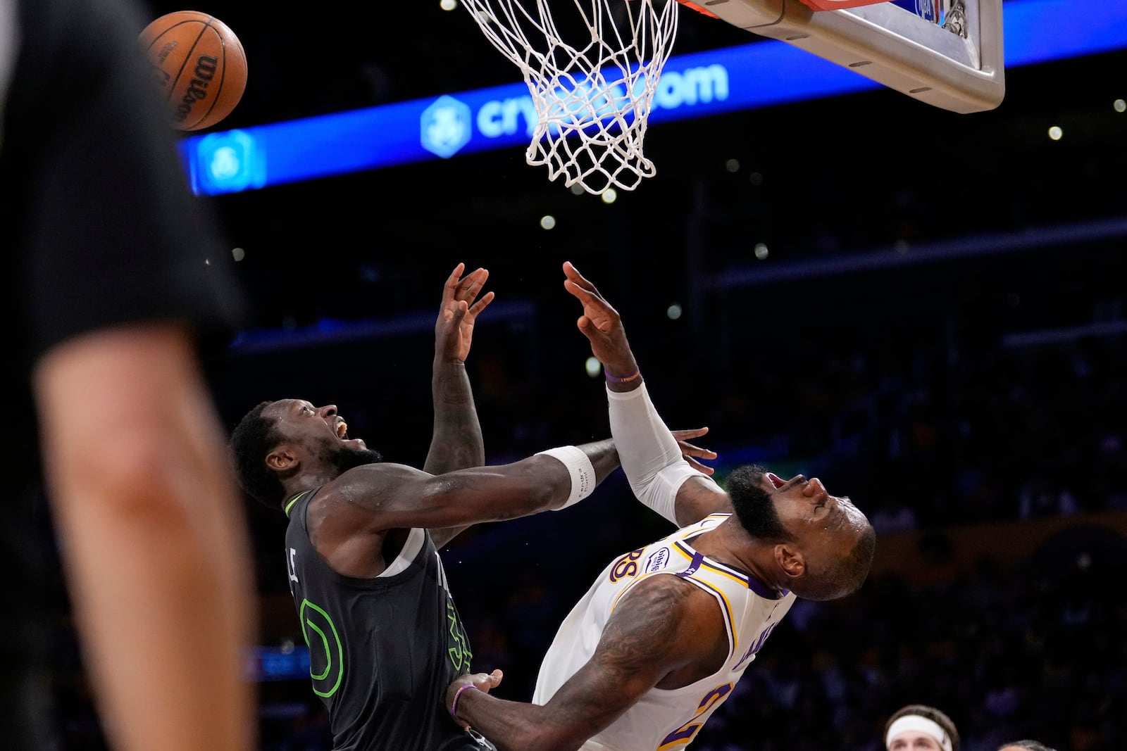 Los Angeles Lakers forward LeBron James, right, reacts after being hit in the face by Minnesota Timberwolves forward Julius Randle as Randle was shooting during the second half in Game 1 of an NBA first-round playoff series Saturday, April 19, 2025, in Los Angeles. (AP Photo/Mark J. Terrill)