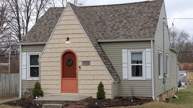Shake-shingle siding gives character to this vinyl-sided bungalow as the shingles wrap around an arched front door to a triangular peak above the formal entry. The exterior design adds to the charm and lends a preview to the interior updates. Contributed photos by Kathy Tyler