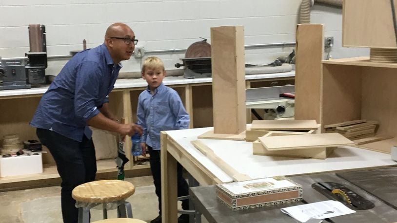 Stephen Mertens and son Hudson explore the wood shop on a tour during Sunday s open house at The Springfield Center for Innovation: The Dome. Photo by Brett Turner