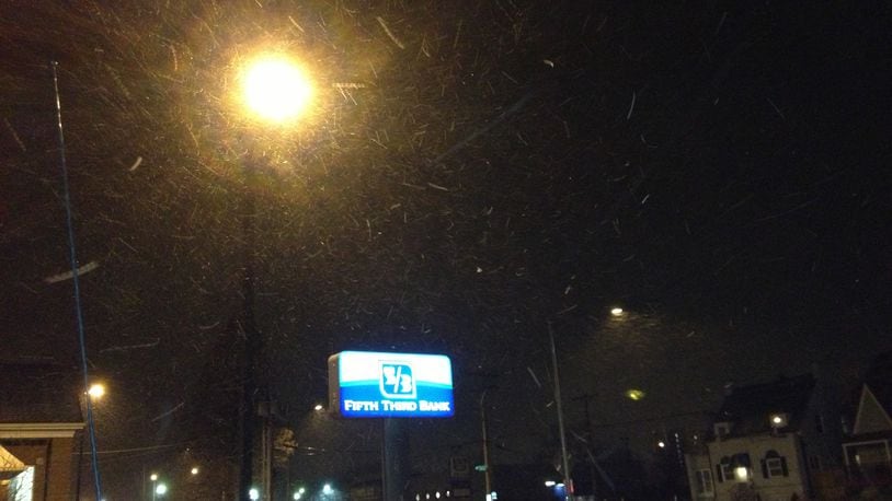 Snow showers fell early Wednesday morning along Patterson Road in Dayton. MIKE CAMPBELL/STAFF