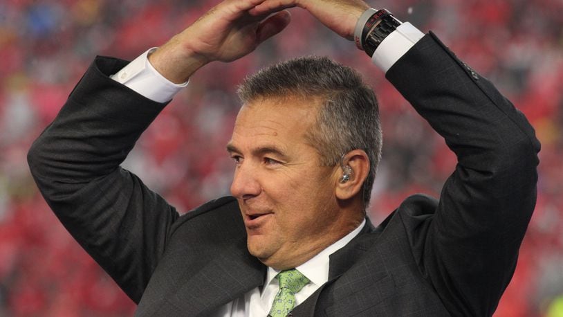 Former Ohio State coach Urban Meyer throws up an "O" during the Fox Sports pregame show before a game against Wisconsin on Saturday, Oct. 26, 2019, at Ohio Stadium in Columbus. David Jablonski/Staff