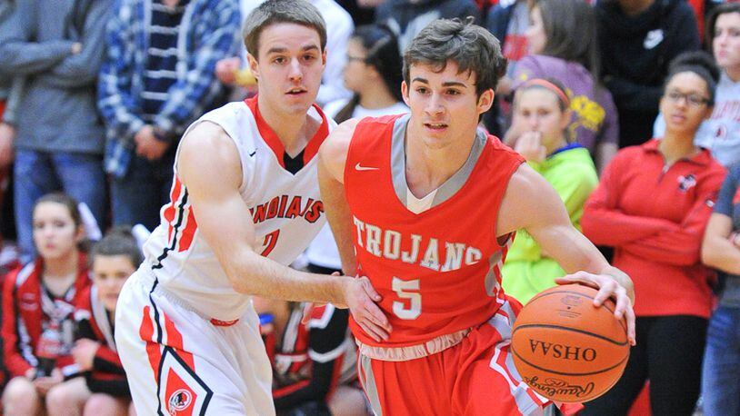 Southeastern senior Trevor King (right) dribbles by Cedarville’s Alex Zaage (left) during an Ohio Heritage Conference game on Friday night. Contributed Photo by Bryant Billing