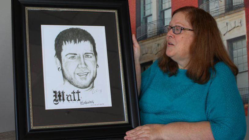 Jerri Jackson, the mother of Matt McQuinn who was killed in 2012 during the Aurora, Colo. theater shooting, is shown with a picture of her late son. JEFF GUERINI/STAFF