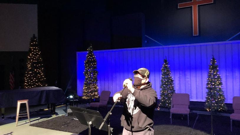 Jon Owings, technical coordinator at First Christian Church, makes adjustments in preparation for upcoming Christmas Eve Services. First Christian is one of several area churches that will offer multiple Christmas Eve services as well as livestreaming. Photo by Brett Turner