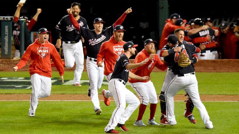 WASHINGTON, DC - OCTOBER 15: Daniel Hudson #44 of the Washington Nationals and Yan Gomes #10 celebrate with teammates after defeating the St. Louis Cardinals to win Game Four of the National League Championship Series at Nationals Park on October 15, 2019 in Washington, DC. (Photo by Will Newton/Getty Images)