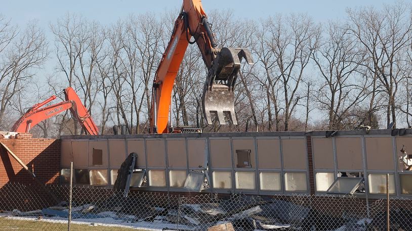A demolition crew tears down Northridge Elementary/Middle School Monday, Feb. 19, 2024. The school has been empty since the students moved into a combined Kenton Ridge School at the beginning of the school year. BILL LACKEY/STAFF